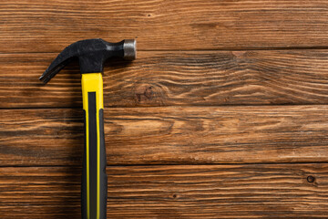 top view of hammer on wooden table, labor day concept