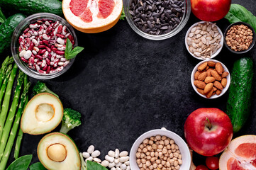 Healthy food. Fresh fruits, vegetables and seeds on a stone background with copy space for your text