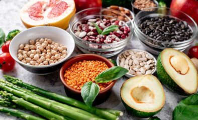 Fresh fruits, vegetables and seeds. Healthy food on a light stone background.