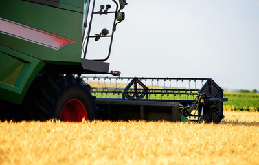 Harvesting campaign. Combine in the wheat field during the harvest. Agricultural concept