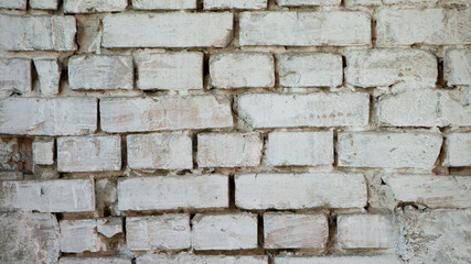 Abstract old white brick wall. background facade brick wall black and white. Vintage old brick wall texture. Grunge stone wall horizontal background. Dilapidated building facade with damaged plaster.