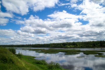 Beautiful landscape with clouds on the river in summer.