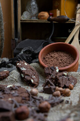 Chocolate cookies with hazelnuts , cocoa and pieces of dark chocolate on the rustic kitchen table