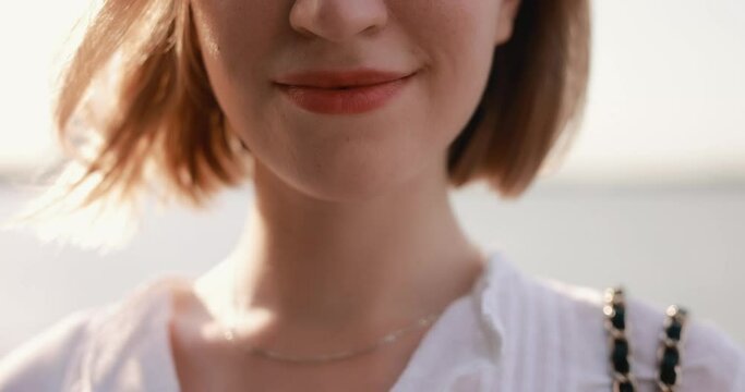 Closeup portrait of wind blows woman hair, slow motion