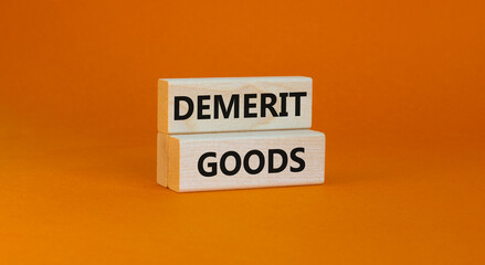 Demerit goods symbol. Wooden blocks with words Demerit goods on beautiful orange background, copy space. Business and demerit goods concept.