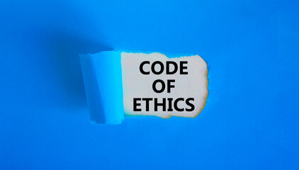 Code of ethics symbol. Words 'Code of ethics' appearing behind torn blue paper. Beautiful blue background. Business, code of ethics concept, copy space.