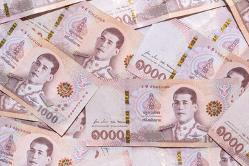 Baht banknotes background. global financial crisis concept. Background of the one thousand baht bills. Many thousand Thai baht banknotes stacked on top of each other. - obrazy, fototapety, plakaty