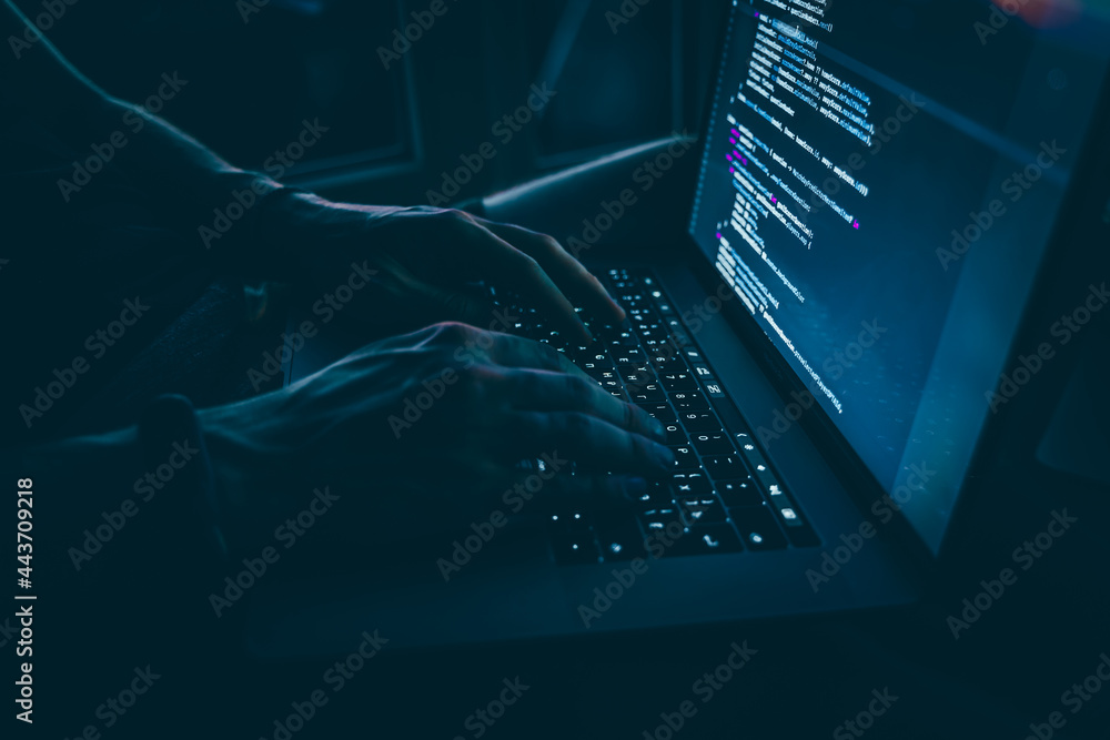 Wall mural the code is on a laptop on a wooden table in front of the window in the dark with a view of the ligh