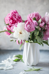 Fresh Peony flowers in vase. bouquet close up. Stylish floral greeting card. Pink peony flower close-up with selective focus.