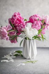 Fresh Peony flowers in vase. bouquet close up. Stylish floral greeting card. Pink peony flower close-up with selective focus.