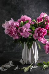 Fresh Peony flowers in vase. bouquet close up. Stylish floral greeting card. Pink peony flower close-up with selective focus.