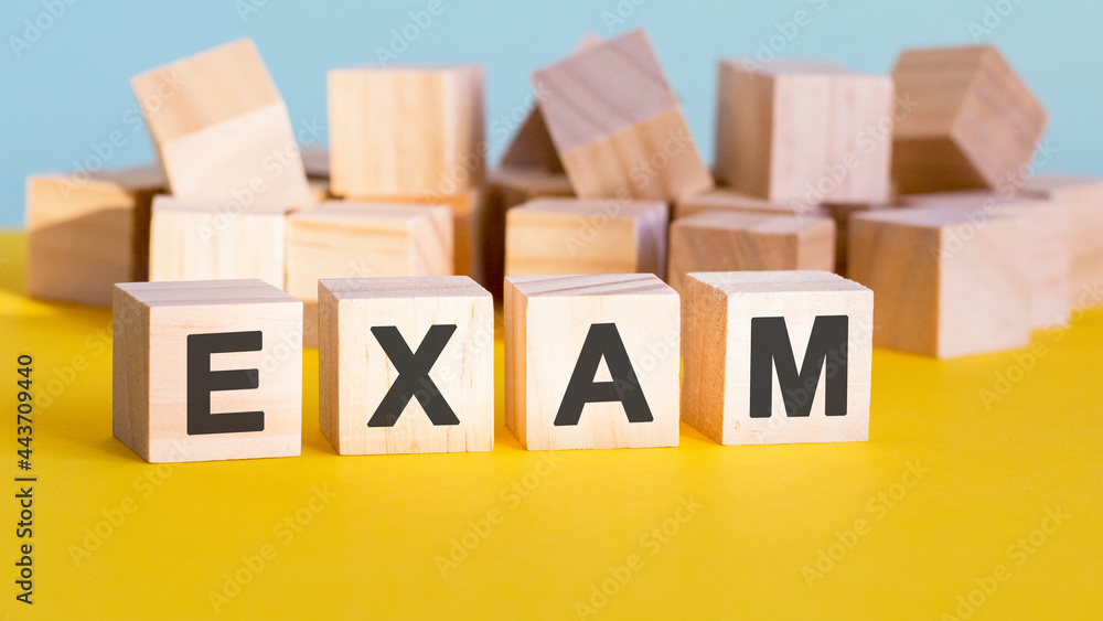 Poster exam word construction with letter blocks and a shallow depth of field