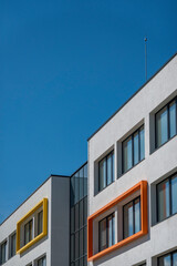 Fragment of modern building facade exterior with blue sky background