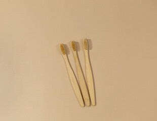 A set of eco friendly bamboo toothbrushes on a beige pastel background. Zero waste, Sustainable lifestyle. Plastic free concept