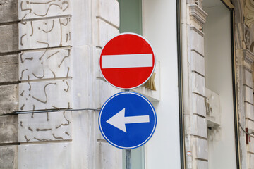 attention: mandatory left turn sign. road sign with a stop sign indicating the direction of traffic...