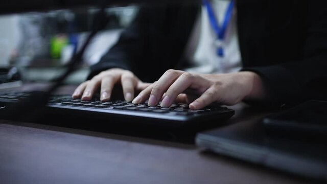 slow motion computer programmer man hand typing configuration on keyboard at laptop for input coding language to software for fix bug and defect of system in data center room , engineering and technol