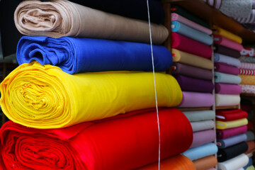dowry and dress fabrics in accordance with Turkish traditions. bridal fabrics. Colorful fabrics were lined up on the shelves of the fabric store. selective focus