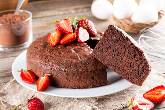 Homemade round chocolate sponge cake or chiffon cake with strawberry. Homemade bakery concept for background and wallpaper