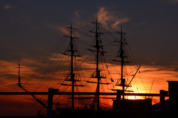 silhouette of the ship's hull against the sunset sky