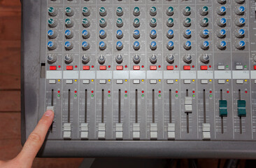 finger on volume. music equipment for sound equalizer
