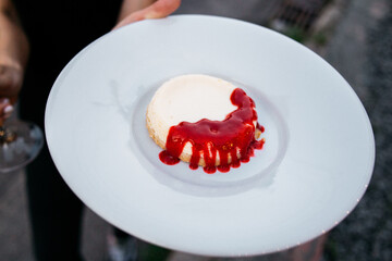panna cotta with strawberry jam  on a plate