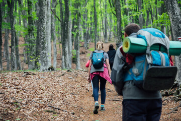 men and women travel in the woods