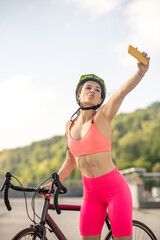 Young pretty girl in bright sportswear with a smartphone making selfie