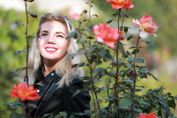 Naklejka premium portrait of a beautiful girl close-up in flowers in the garden