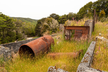 Remains in the landscape of an old mining factory in the ghost town of Waiuta, New Zealand