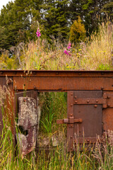 Remains in the landscape of an old mining factory in the ghost town of Waiuta, New Zealand
