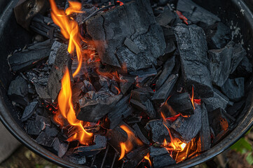 burning embers in a grill in the backyard, preparation for barbecue