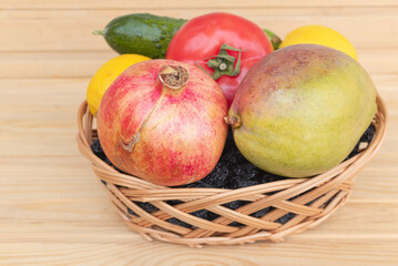 Closeup shot of fruits and vegetables in a basket on a table