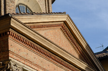 particular architecture, gable facade of a neo-classical building with exposed brick, with cornice,...