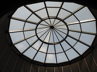 Glass dome or round window in the roof. The sky can be seen through a glass transparent structure...