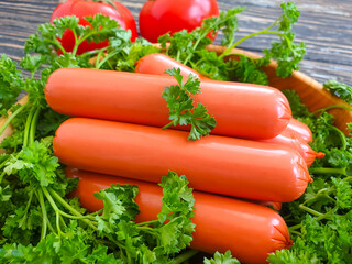 greens, tomato on a wooden background