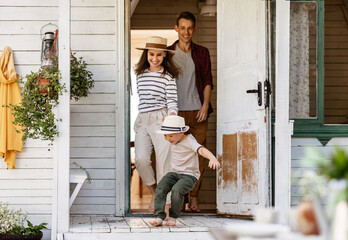 cheerful family is having a rest and having fun and run out of country house