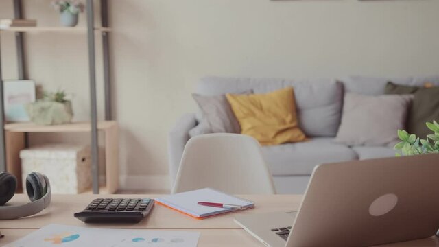Close up view of empty employee desk workplace with computer and documents on it. Home office worker table workspace with laptop and papers and journal. Business employment concept.