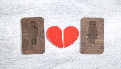 Broken heart with a wooden male and female symbols.