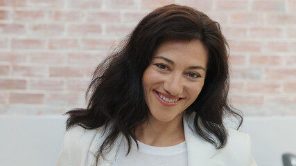 Portrait of a smiling 45 year old Spanish woman looking at camera. Entrepreneurial woman, empowered woman	