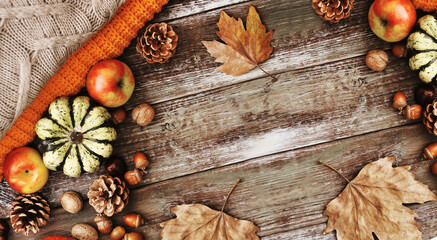 autumn leaves, apples, nuts, pumpkin, sweater on wooden texture, cozy autumn background