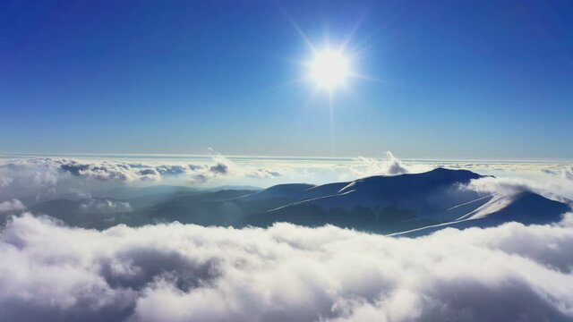 Wonderful view of extraordinary cloudy valley and bright orange sunset