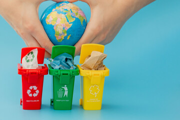 Yellow, green and red recycle bins with recycle symbol on blue background. Keep city tidy, Leaves...