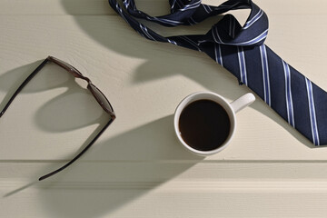 coffee mug with tie and sunglasses