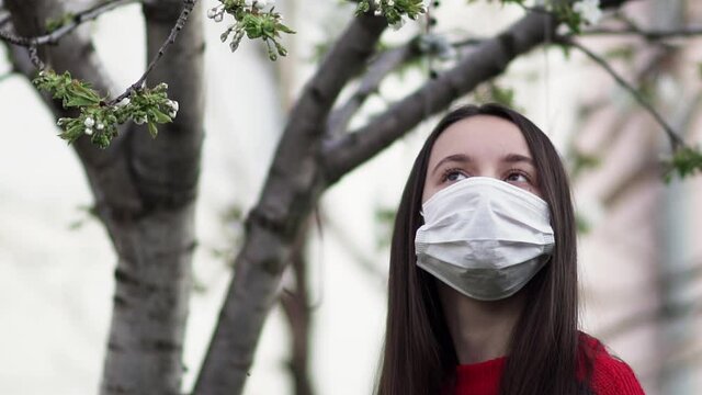 Woman in mask in - enjoy corona virus quarantine in the garden