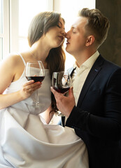 newlyweds in love hug, kiss and drink wine, happiness and anticipation of a happy life