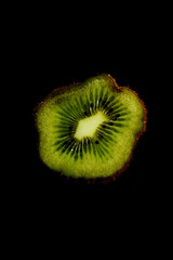 Green Kiwi texture. It have rows of tiny, black, edible seeds inside.