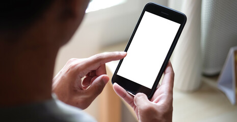 Close up view of male hands using smart phone with modern office blurred background. Blank screen...