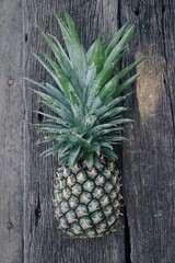 Pineapple tropical healthy fruit on brown wood table background