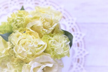 白木の背景に黄色の花束のある女性的なテーブルフォト