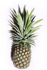 Fototapeta premium Pineapple tropical fruit and shadow on isolated white background